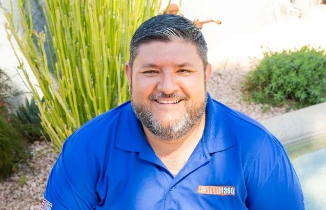 Plumbing 360 team member outside in a company polo shirt
